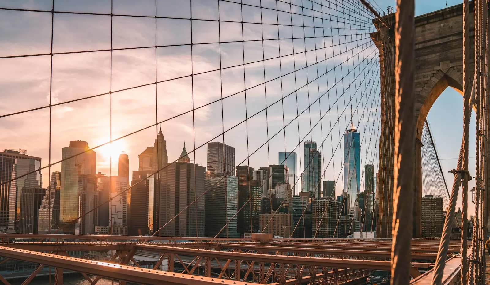 New York City skyline viewed through the Brooklyn Bridge